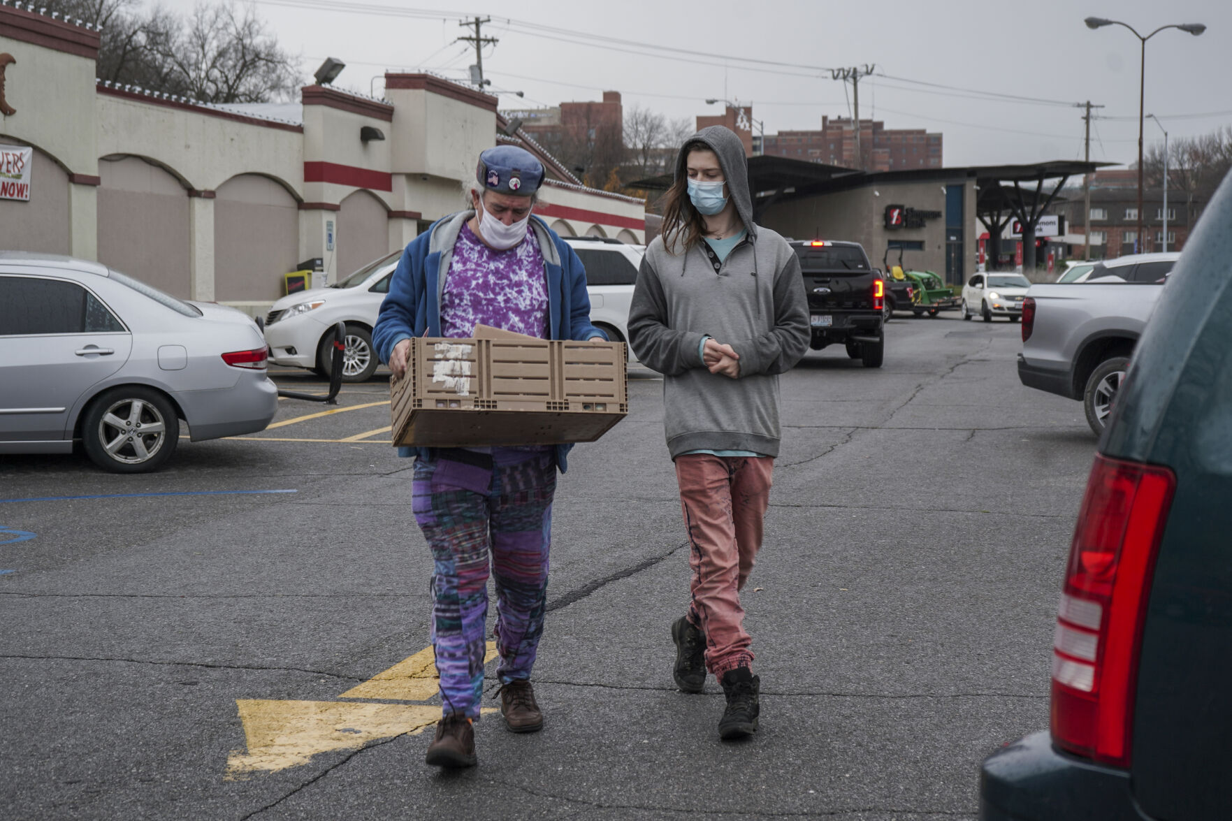 Robert Morrison walks to his van with Greyson Miller